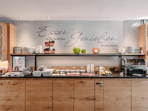 a kitchen with a counter with food on it at Alpinhotel Monte Superior - Silvretta Card Premium Betrieb in Galtür