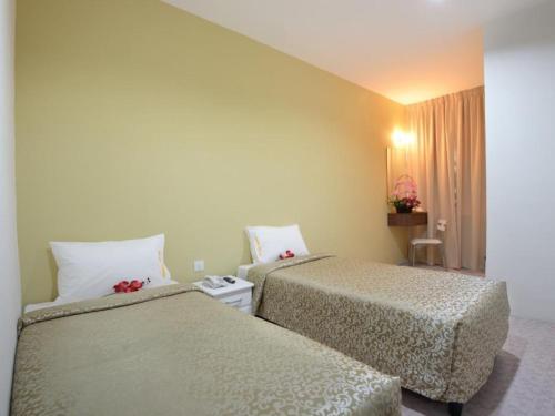 Postel nebo postele na pokoji v ubytování Swing & Pillows - Grand Inn George Town Penang