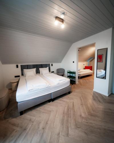 a bedroom with a large white bed in a room at Boutique Villa Vanilla in Csopak
