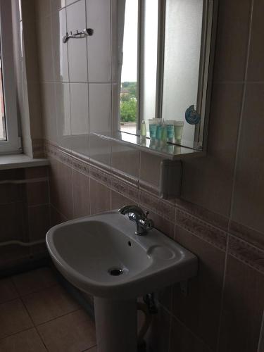 a white sink in a bathroom with a window at U Fedora in Oleksandriya