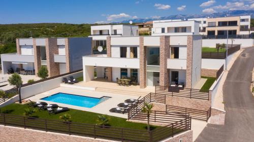 an image of a house with a swimming pool at Villas Royal III in Novalja