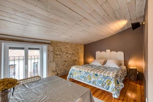 a bedroom with a bed and a large window at Calmacé in Gignac