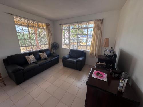 a living room with a couch and a chair at 毛里求斯民宿 in Roche Bois
