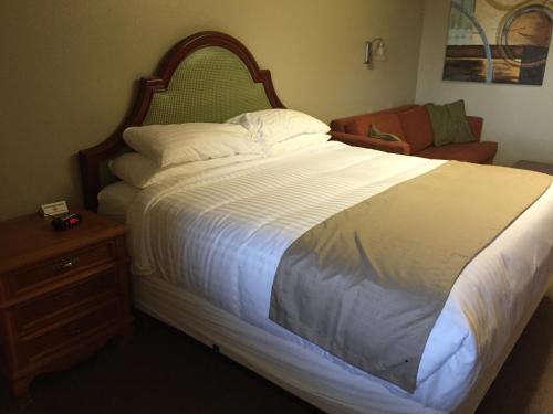 a bedroom with a large bed with a wooden headboard at Gateway Inn in Lyman