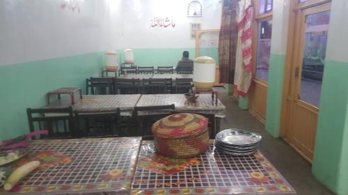 a room with tables and a hat on a table at Abu Dhabi Palace in Dargai