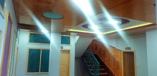 a room with a hallway with lights on the ceiling at Abu Dhabi Palace in Dargai