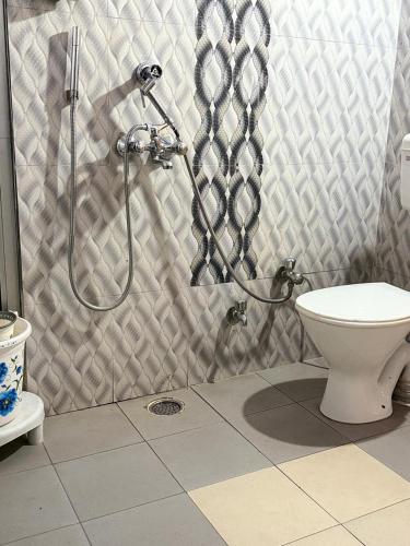 a bathroom with a shower and a toilet at Crown Plaza Heritage in Jodhpur