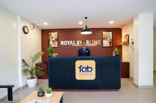 a man standing at a podium in a lobby at Via Royal Sterling in Bengaluru