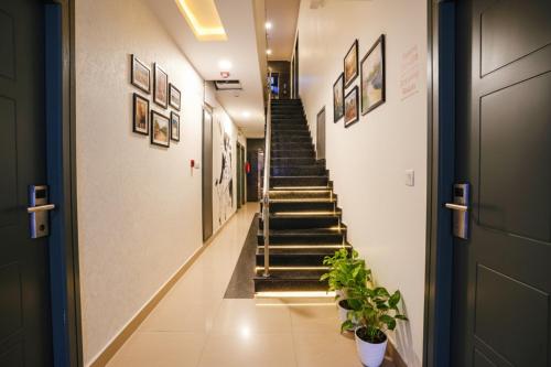a hallway with stairs in a building with potted plants at Via Royal Sterling in Bengaluru