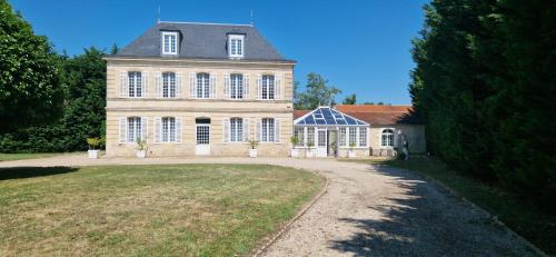 a large house with a large yard in front of it at Suite Majorelle du Château in Gaillan-en-Médoc