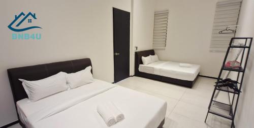 Ein Bett oder Betten in einem Zimmer der Unterkunft Urban Suites Apartment In Jelutong George Town