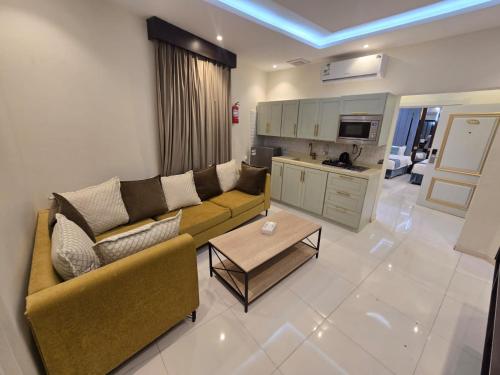 a living room with a couch and a table at الجوهرة سويت للشقق المخدومة in Shahār