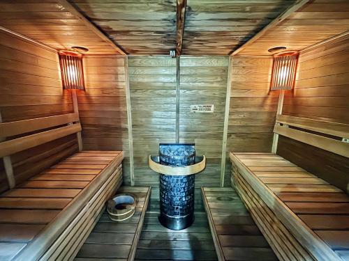 a sauna with a tub in the middle at Suite Escapes Brenthill Baguio 1 Bedroom in Baguio