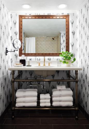a bathroom with a sink and a mirror at Graduate by Hilton State College in State College