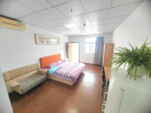 a room with a couch and a bed in it at Suhe Homestay in Nanjing