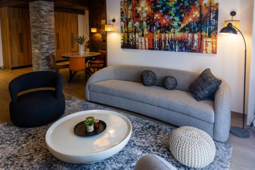 a living room with a couch and a table at New Gudauri Ski4Life in Gudauri