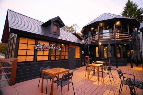 a patio with tables and chairs in front of a building at Fuji Elegance Hotel in Yamanakako