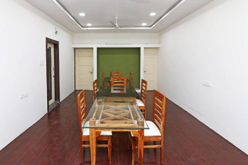 a dining room with a table and chairs at Hotel O Krishna Hotel and Restaurant in Raipur