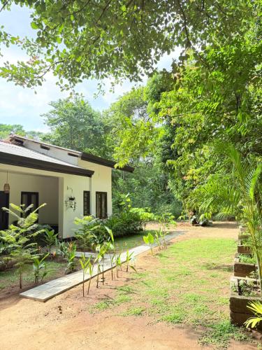a house with a garden in front of it at Sigiri Bloom Villa in Sigiriya