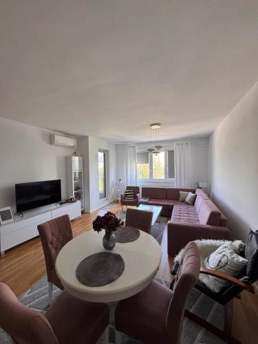 a living room with a couch and a table at Apartman IsTar View in Sarajevo