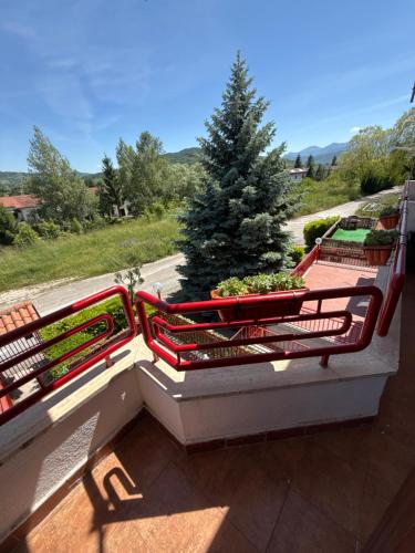 two benches on a balcony with a christmas tree at Casa serenaurora in Castel di Sangro