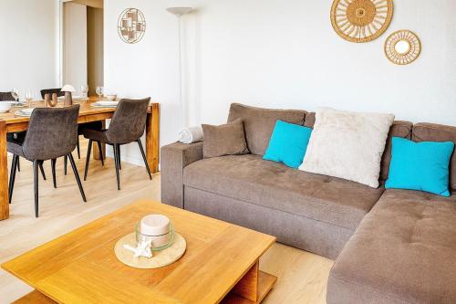 a living room with a couch and a table at Cozy Marquette apartment 10 min from Lille center in Marquette-lès-Lille