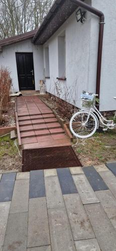 a bike is parked in front of a house at Zamek Bożejów - Agroturystyka in Radomierowice