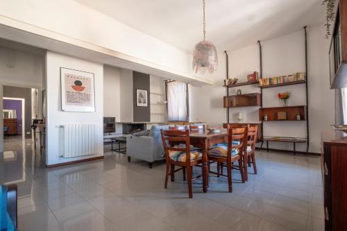 a dining room and living room with a table and chairs at san Lorenzo by the sea in Augusta