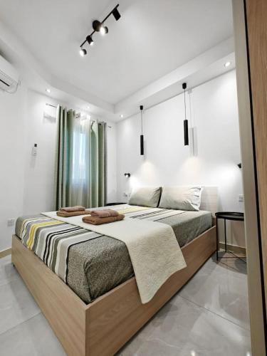 a bedroom with a large bed with towels on it at Valley View 2 in Luqa