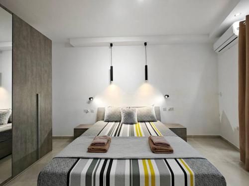 a bedroom with a large bed with towels on it at Valley View 1 in Luqa