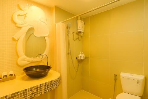 a bathroom with a sink and a shower with a bowl at River Breeze Chiangsaen in Chiang Saen