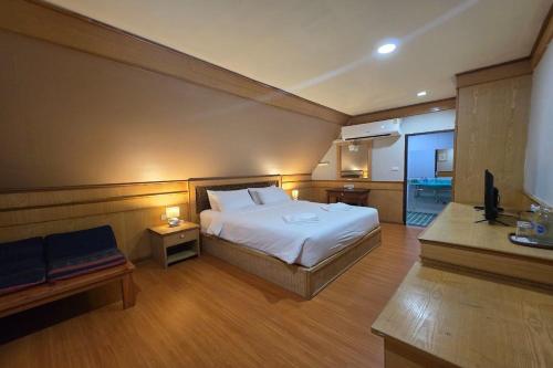 a bedroom with a bed and a television in it at River Breeze Chiangsaen in Chiang Saen