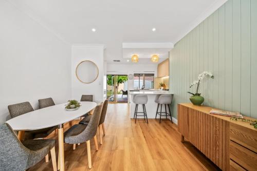 a kitchen and dining room with a table and chairs at Short Stay Sanctuary - Close to airport in Perth