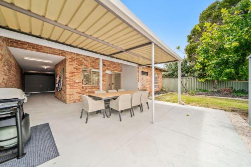 a patio with a table and chairs and a grill at Short Stay Sanctuary - Close to airport in Perth