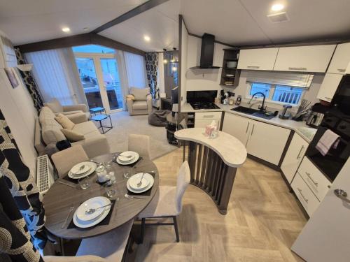 a kitchen and living room with a table and chairs at Sirrah Villa - Whitstable, Family & Pet friendly in Seasalter