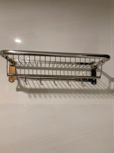 a metal shelf on a wall in a room at LushStay Cao Bá Quát in Hanoi