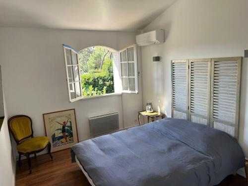 a bedroom with a blue bed and a window at 3 Bedroom 2 Bath Villa Private Pool in Mougins in Mougins