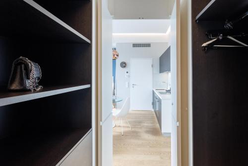 a small apartment with black walls and a hallway at Penthouse-Flair with Skyline-View in Vienna