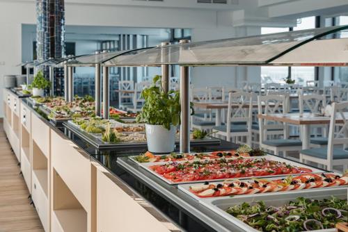 a buffet line with salads and vegetables on display at Apartamenty Rewita Bursztyn in Jurata