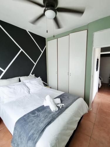 a bedroom with a large white bed with a ceiling at Home Away from Home 2 in Margate