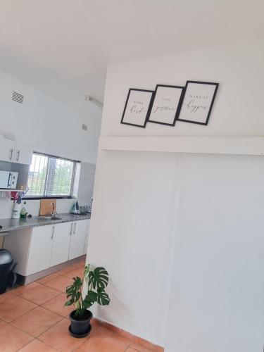 a kitchen with four pictures on a wall at Home Away from Home 2 in Margate