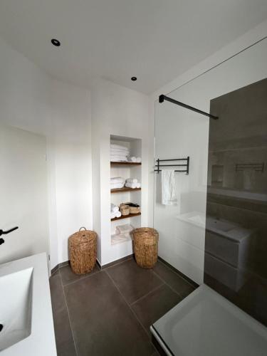a white bathroom with a sink and a shower at Domizil Frutania in Bad Neuenahr-Ahrweiler