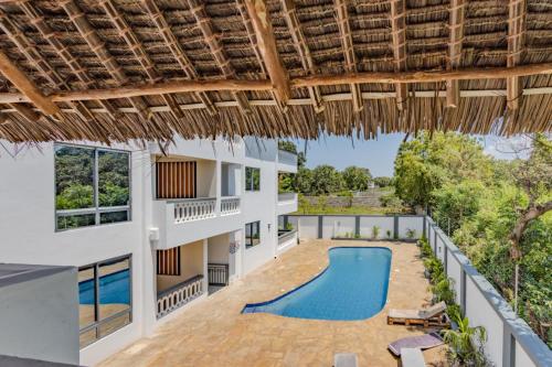 an exterior view of a villa with a swimming pool at Casa Nampala Diani in Ukunda