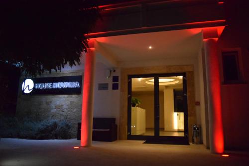 a building with red lights in front of a door at House Novalia in Novalja