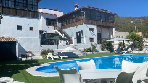 a house with a swimming pool in front of a house at Ziggy's Mountain Retreat in Vilaflor