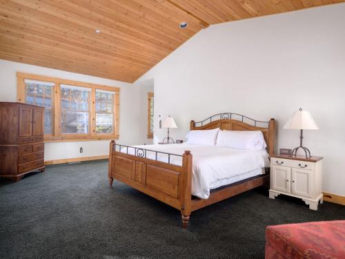 a bedroom with a large bed and a wooden ceiling at RMR: Granite Ridge Homestead 3134 in Teton Village in Teton Village