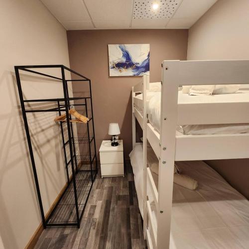 a room with three bunk beds and a lamp at Ziggy's Mountain Retreat in Vilaflor