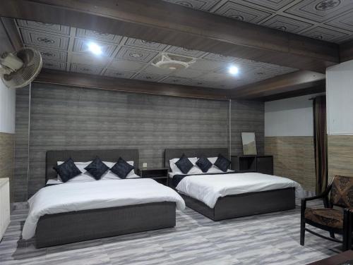 Ένα ή περισσότερα κρεβάτια σε δωμάτιο στο But Tourist Inn Hotel Murree