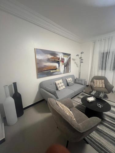 a living room with a couch and a table at Farid Street - Studio - Dakar Plateau in Dakar