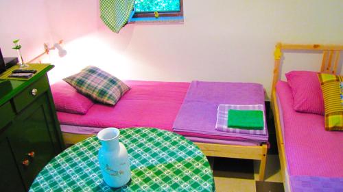 a room with a bed and a table with a water bottle at Room Galina in Duga Resa